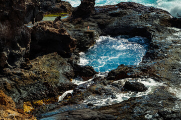 Volcanic rock pools at Piscinas Naturales de Los Abrigos, Tenerife South. Powerful Atlantic waves...