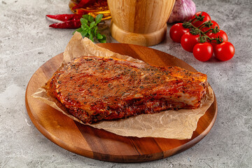 Raw marinated pork loin steak