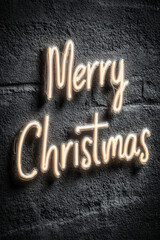 Merry Christmas design glowing on charcoal gray background