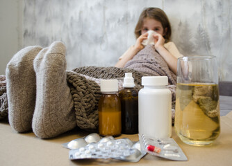 A little girl is lying in bed sick. The concept of illness, cold, acute respiratory viral infection