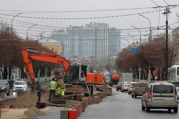 Repairing a heating main under a city street. Preparing for the heating season