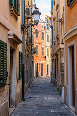 Picturesque street with cobbled floor and colorful old houses in the coastal town of Piran, Slovenia.