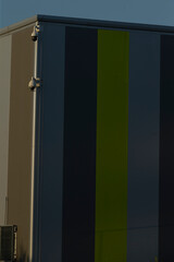 A modern industrial structure featuring bold vertical color stripes, capturing contemporary architecture aesthetics.