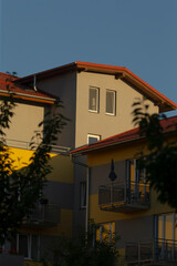A striking view of contemporary buildings featuring a mix of muted and vibrant colors set against a clear sky.