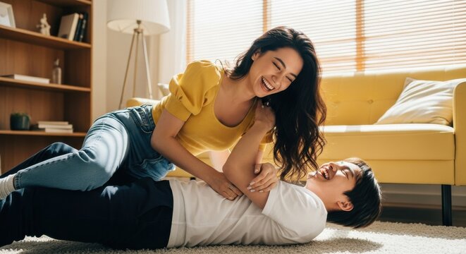 Couple enjoys playtime and laughter in bright living room filled with natural light during afternoon relaxation - Powered by Adobe