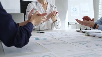 Business people team clapping hands in meeting celebrating success with financial charts, data analysis, and teamwork achievement in modern office - Powered by Adobe
