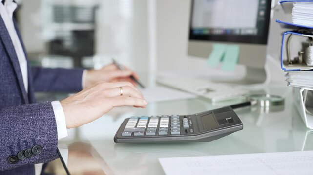 Accountant calculating finances at office desk, person analyzing budget, doing bookkeeping, managing taxes and data. Audit and taxes in business