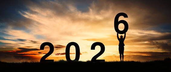 Silhouette of a strong business woman standing at dawn already active and motivated, greeting card for the new year 2026.