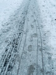 traces on snow. Winter promenade in the city. winter trail with shoe print, winter background.