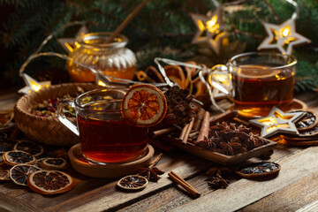 Christmas herbal tea with ingredients on a old wooden table.