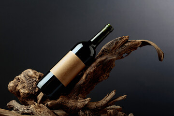 Fototapeta premium Bottle of red wine with empty label on a old snags.