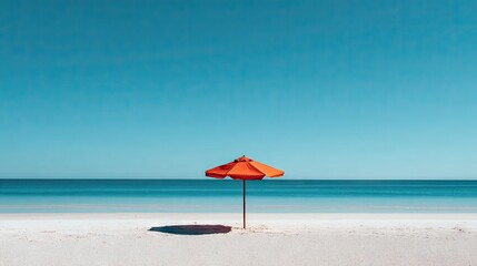 Tranquil beach scene with a lone umbrella.