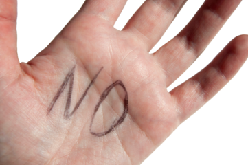 A hand close-up with NO sign on it isolated. A close-up of a palm with a stop sign.