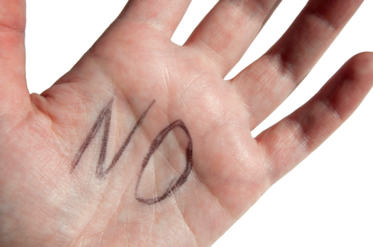 A hand close-up with NO sign on it isolated. A close-up of a palm with a stop sign.