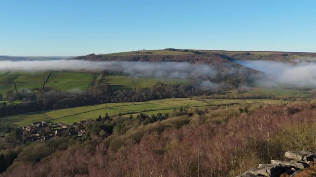 Scenic Cloud Inversion at the Peak District National park in the UK.  Cinematic Drone Landscape Exploration around Froggatt Edge, Curbar Edge and Baslow Edge, which are the most popular hiking trails.