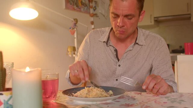 white man picking at teeth after dinner, candle and lamp glow, slightly embarrassed expression, casual solo diner