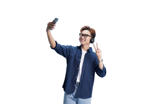 Selfie Time with a Smile: An individual, radiating positivity with headphones on, captures a selfie, flashing a peace sign, creating a moment of connection.