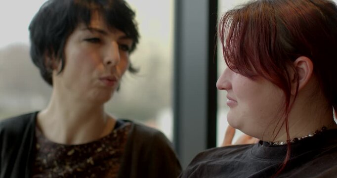 Warm cafe scene with engaged women talking, Two women exchanging deep thoughts over coffee in cozy cafe, Intimate moment captured as women converse earnestly in welcoming cafe setting