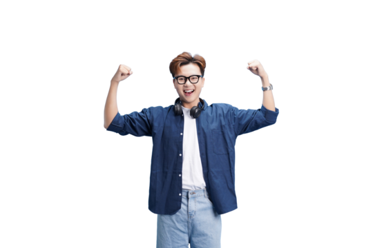 Joyful man celebrating: An enthusiastic man, full of youthful energy, celebrates with raised arms, smiling broadly with headphones around his neck, capturing his happiness. 