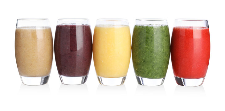 Different tasty smoothies in glasses isolated on white