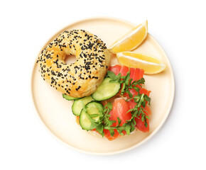Delicious bagel with salmon, cucumber, arugula and lemon isolated on white, top view