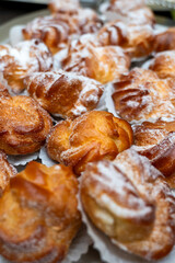 tray of delicious sweet cream puffs at a business event