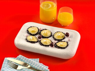 A beautiful arrangement of gourmet ravioli is artfully displayed on a striking surface, accompanied by refreshing drinks, creating a lively dining atmosphere