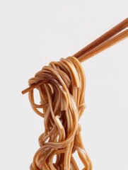 Brown Noodles Held by Chopsticks in Light Background