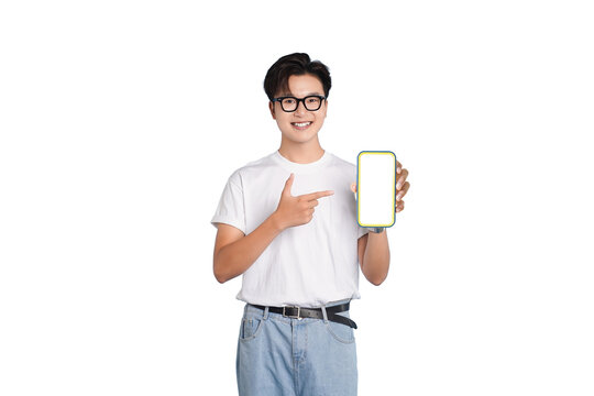 Smart Demonstration: A young man wearing glasses, cheerfully presenting a modern smartphone with a blank screen, pointing directly at the device in a gesture of showcase and user interface.