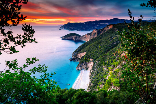 Sunset on the coast Corfu seen from above. Aerial view of Stelari and Chomi beaches. The most beautiful landscapes of Greek island in the Ionian Sea.