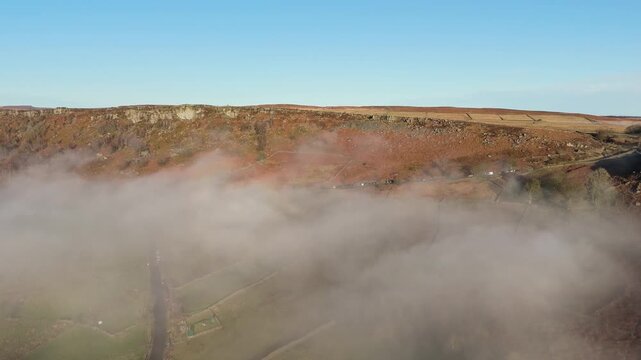 Scenic Cloud Inversion at the Peak District National park in the UK.  Cinematic Drone Landscape Exploration around Froggatt Edge, Curbar Edge and Baslow Edge, which are the most popular hiking trails.