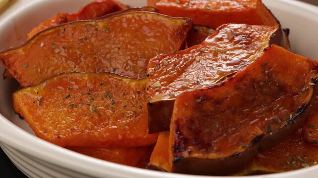 roasted pumpkin with herbs in baking dish rotation food