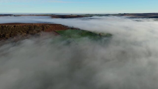 Scenic Cloud Inversion at the Peak District National park in the UK.  Cinematic Drone Landscape Exploration around Froggatt Edge, Curbar Edge and Baslow Edge, which are the most popular hiking trails.