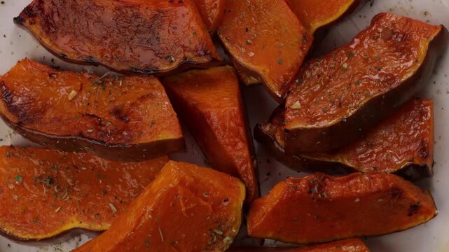 roasted pumpkin with herbs on plate close up rotation food - Powered by Adobe