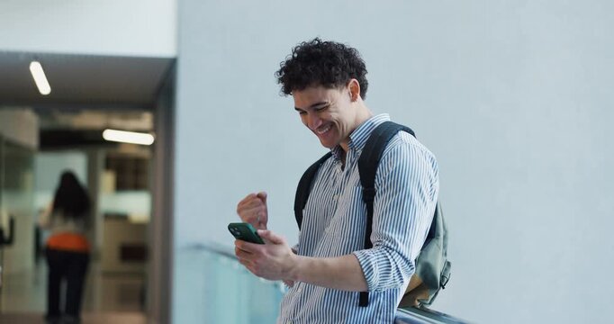 Happy man, winning and surprise with phone for internship acceptance or good news on campus. Excited, male person or junior intern with smile, mobile smartphone or career opportunity for job success