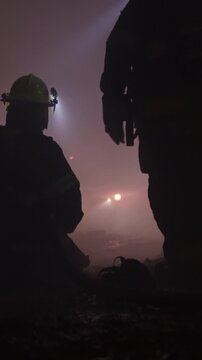 Rescue forces search for survivors inside a dark tunnel using flashlights