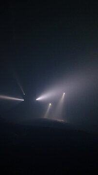 Rescue forces search for survivors inside a dark tunnel using flashlights