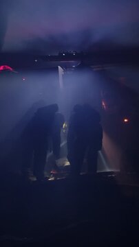 Rescue forces search for survivors inside a dark tunnel using flashlights