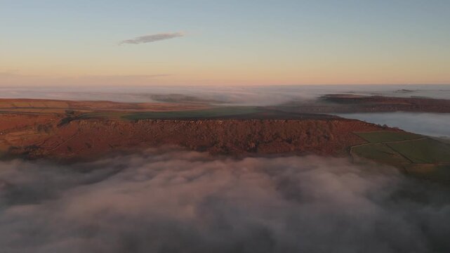 Scenic Cloud Inversion at the Peak District National park in the UK.  Cinematic Drone Landscape Exploration around Froggatt Edge, Curbar Edge and Baslow Edge, which are the most popular hiking trails.
