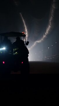 Rescue forces search for survivors inside a dark tunnel using flashlights