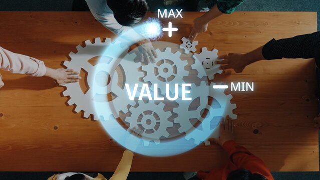 A team collaborates around a wooden table, utilizing gears to symbolize value optimization in business strategy. The scene highlights teamwork and innovation. Raster