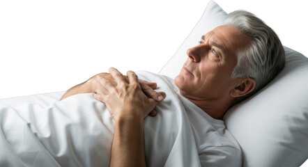 Elderly man with gray hair lying on his side in bed resting on a white pillow with hands crossed over his chest looking upward thoughtfully isolate