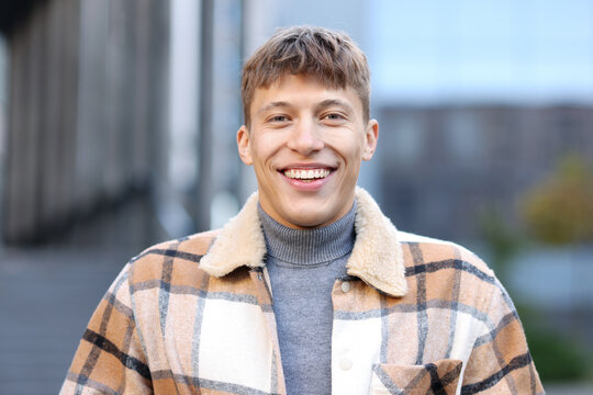 Portrait of smiling man in shirt on city street
