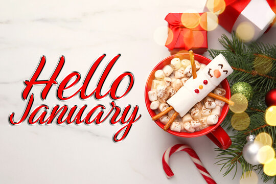 Hello January, winter time card. Snowman made of marshmallows in cup of cocoa on table