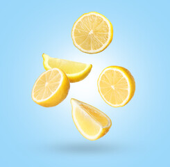 Fresh lemons falling on light blue background. Citrus fruit