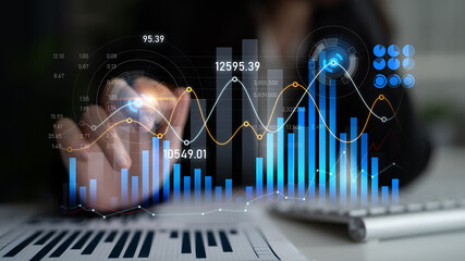 A business professional engaged in financial analysis using digital graphs and charts highlights growth trends and investment opportunities in a modern office setup. Scalp