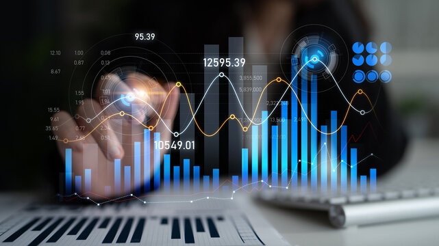 A business professional engaged in financial analysis using digital graphs and charts highlights growth trends and investment opportunities in a modern office setup. Scalp