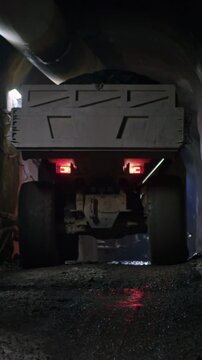 Large construction trucks working inside a tunnel