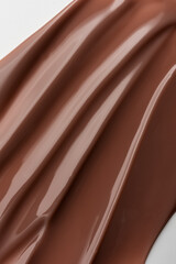 Smooth melted chocolate texture with soft light reflections