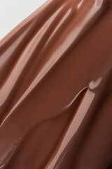 Smooth melted chocolate texture with soft light reflections